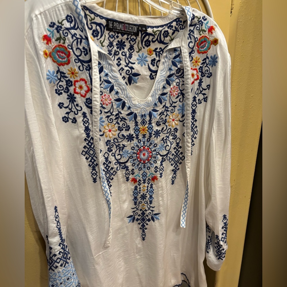 The Pyramid Collection White Tunic with Navy and Multicolor Floral Embroidery.